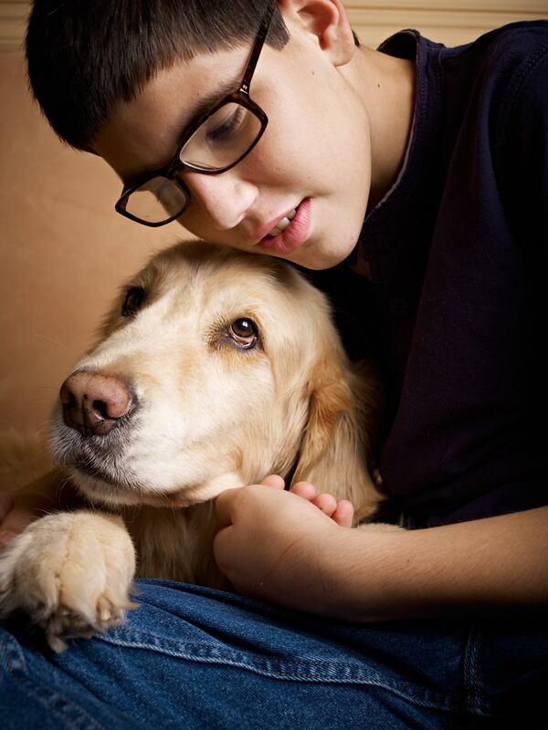 Iyal Winokur, born with fetal alcohol syndrome, with his service dog Chancer. Iyal was adopted from a Russian orphanage. CONTRIBUTED BY HAROLD DANIELS