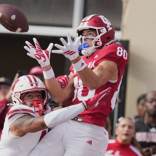 FILE - Indiana wide receiver Charlie Becker makes a touchdown catch over Wisconsin safety Austin Brown (9) during the first half of an NCAA college football game, Saturday, Nov. 15, 2025, in Bloomington, Ind. (AP Photo/Darron Cummings, file)