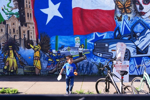 Luca Fernandez, 5, walks in front of a mural made by artist Jesus Alba to commemorate the 1862 battle of Puebla between the French and Mexican army during a Cinco De Mayo celebration in the Oak Cliff section of Dallas, May 3, 2025. (AP Photo/LM Otero)