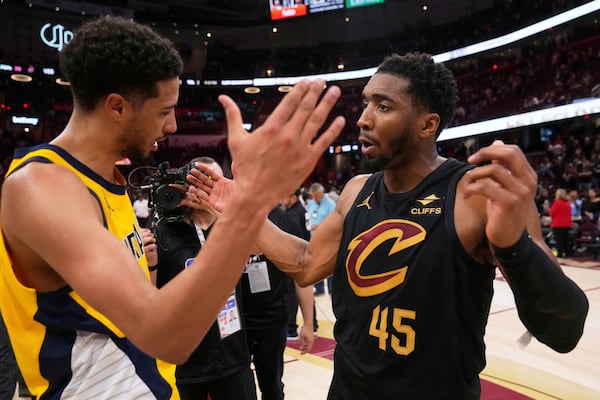 Indiana Pacers guard Tyrese Haliburton, left, and Cleveland Cavaliers guard Donovan Mitchell greet each other after the Pacers defeated the Cleveland Cavaliers 114-105 in Game 5 of an Eastern Conference semifinal NBA basketball playoff Tuesday, May 13, 2025, in Cleveland. (AP Photo/Sue Ogrocki)
