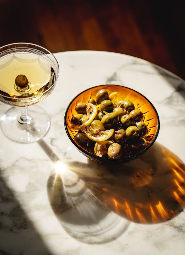 Give jarred olives some holiday flair by whipping up this roasted lemons and olives recipe, adapted from “A Table” by Rebekah Peppler. (Courtesy of Chronicle Books/Joann Pai)