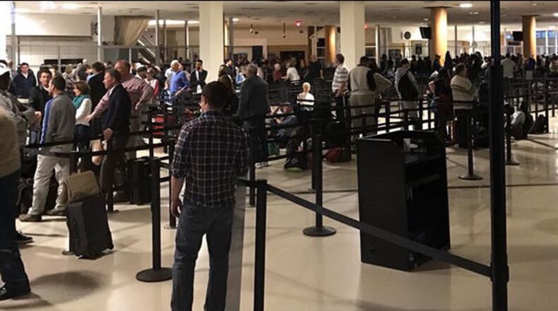 Passengers wait in the terminal at Hartsfield-Jackson International Airport.
