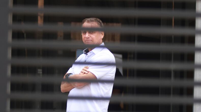 FILE - Brazil's former President Jair Bolsonaro stands at the entrance of his home where he is under house arrest in Brasilia, Brazil, Tuesday, Sept. 2, 2025. (AP Photo/Luis Nova, File)
