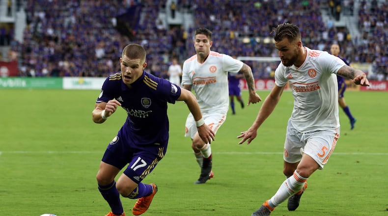 Atlanta United’s Leandro Gonzalez Pirez chases down Orlando City’s Chris Mueller during Sunday’s match.