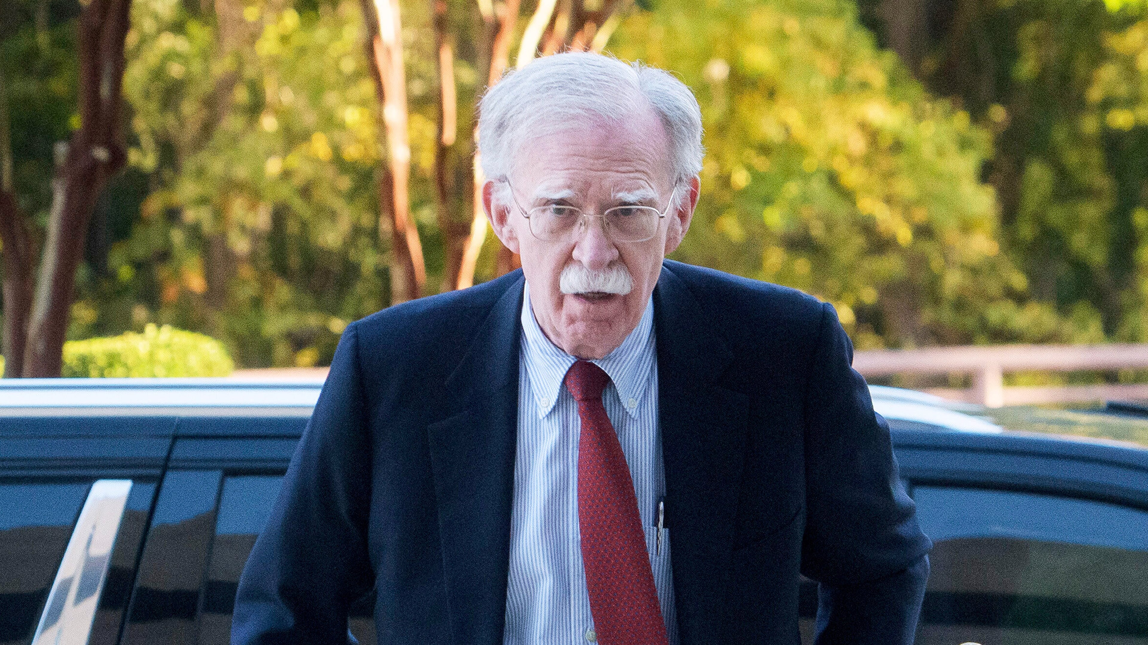 Former Trump administration national security adviser John Bolton, left, arrives for his arraignment at the Greenbelt Federal Courthouse in Greenbelt, Md., Friday, Oct. 17, 2025. (AP Photo/Rod Lamkey, Jr.)