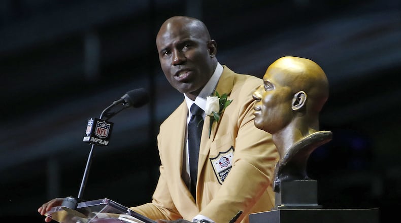 Former NFL player Terrell Davis speaks behind a bust of himself during an induction ceremony at the Pro Football Hall of Fame Saturday, Aug. 5, 2017, in Canton, Ohio. (AP Photo/Ron Schwane)