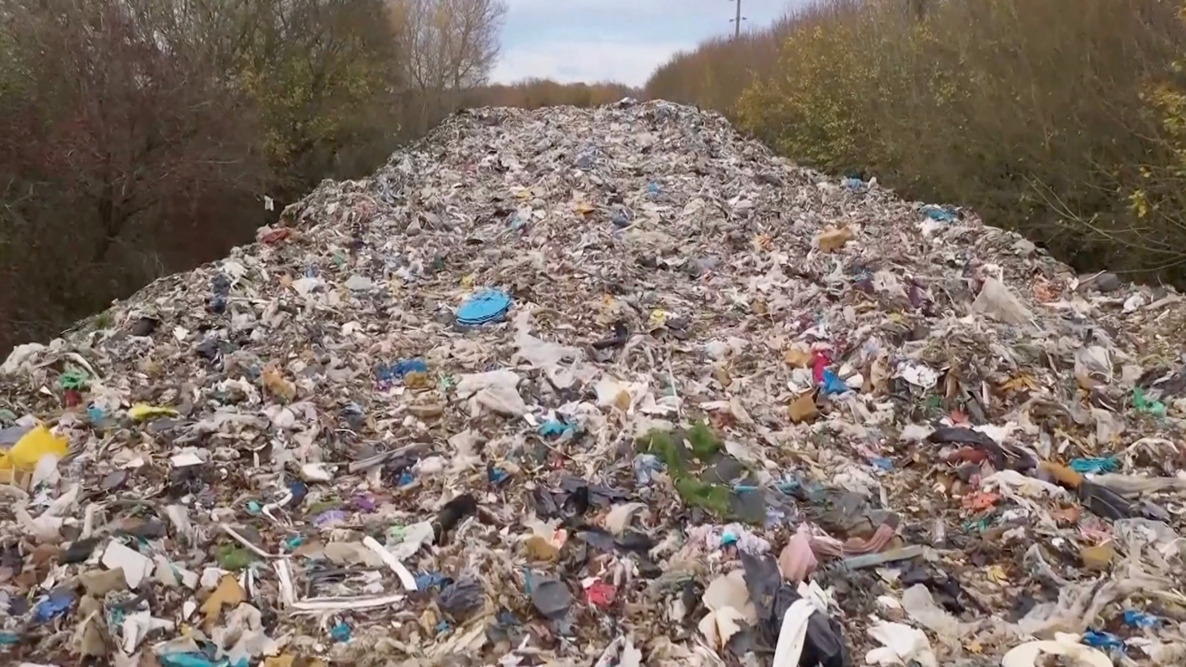 This image taken from video shows hundreds of tonnes of waste dumped in a field in the UK, near Kidlington in Oxfordshire, Nov. 16, 2025. (Sky News via AP)