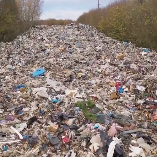 This image taken from video shows hundreds of tonnes of waste dumped in a field in the UK, near Kidlington in Oxfordshire, Nov. 16, 2025. (Sky News via AP)