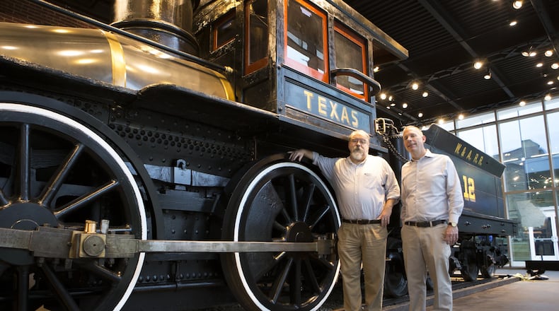 Gordon Jones (left), senior military historian, and Jackson McQuigg, vice president of properties, pose for a portrait next to the Texas, as they prepare for the opening of the new exhibit at the Atlanta History Center. Contributed by Casey Sykes