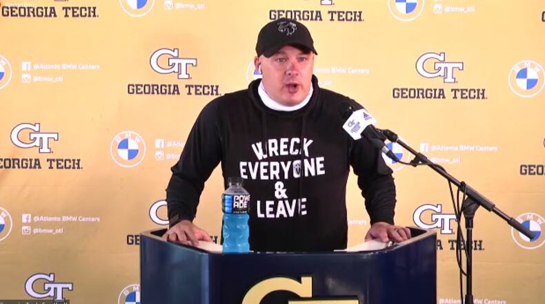 Georgia Tech coach Geoff Collins addresses media via videoconference April 13, 2021. Collins was wearing a shirt bearing the "Wreck Everyone & Leave" slogan of WWE wrestler Roman Reigns, aka Joe Anoa'i, the former Tech football captain. Collins was honoring Reigns for his Universal championship at WrestleMania 37, held Sunday.