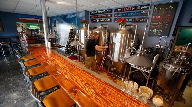 Ron Shea, the owner and brewer at R. Shea Brewing, cleans the fermentor at the brewery Wednesday, Dec. 2, 2015 in Akron, Ohio. (Karen Schiely/Akron Beacon Journal/TNS)
