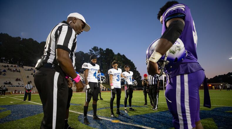 The referee tosses a coin before a GHSA high school football game between Stephenson High School and Miller Grove High School at James R. Hallford Stadium in Clarkston, GA., on Friday, Oct. 8, 2021. (Photo/Jenn Finch)