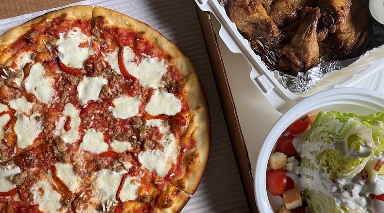 Pizza, wings and a wedge salad are among the takeaway offerings at Two Birds Taphouse in Marietta. CONTRIBUTED BY BOB TOWNSEND