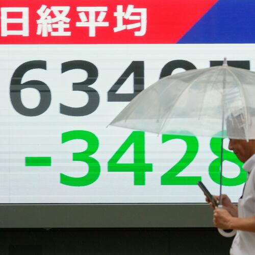 A person walks in front of an electronic stock board showing Japan's Nikkei index at a securities firm Friday, July 17, 2026, in Tokyo. (AP Photo/Eugene Hoshiko)