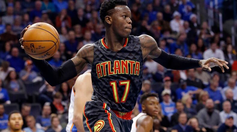 Atlanta Hawks guard Dennis Schroder (17) passes from under the basket in the fourth quarter of an NBA basketball game against the Oklahoma City Thunder in Oklahoma City, Monday, Dec. 19, 2016. Atlanta won 110-108. (AP Photo/Sue Ogrocki)