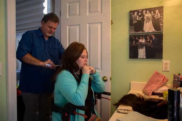 Because Lisa Martin lost her hair during her treatment for COVID-19, she wears wigs. Her thick dark brown hair is growing back. Her husband, Jeff, helps her with everyday tasks, even serving as a hairdresser when needed. (AJC Photo/Stephen B. Morton)