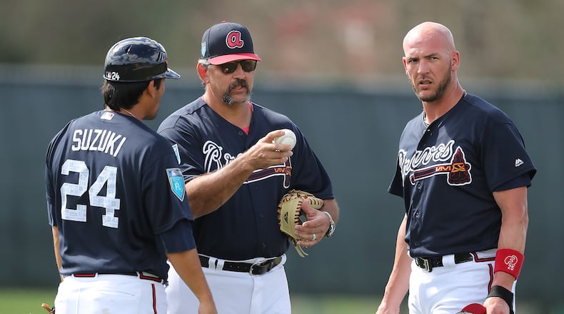 Sal Fasano works with veteran Braves catchers Kurt Suzuki and Tyler Flowers during a spring-training workout.
