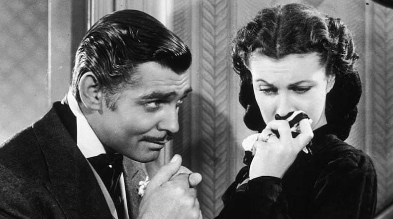 American actor Clark Gable (1901 - 1960) in his role as Rhett Butler kissing the hand of a tearful Scarlett O'Hara, played by Vivien Leigh in 'Gone With The Wind'.   (Photo by Hulton Archive/Getty Images)