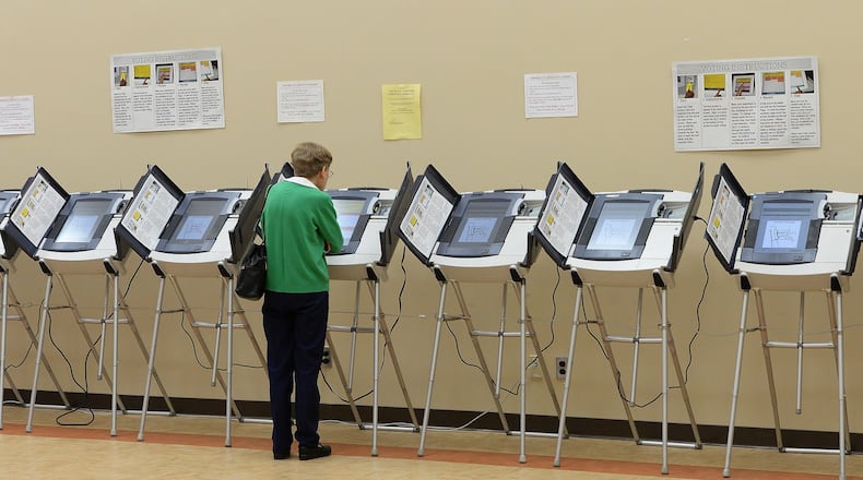 October 30, 2013 -Atlanta: One voter uses a voting machine at the North Fulton Service Center on Wednesday, October 10, 2013. Over 100 voters cast there vote at this site today. This was one of the many early voting sites available to voters today. JOHNNY CRAWFORD / JCRAWFORD@AJC.COM
