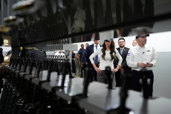 Homeland Security Secretary Kristi Noem looks at weapons during a tour of the Terrorist Confinement Center in Tecoluca, El Salvador, Wednesday, March 26, 2025. (AP Photo/Alex Brandon)