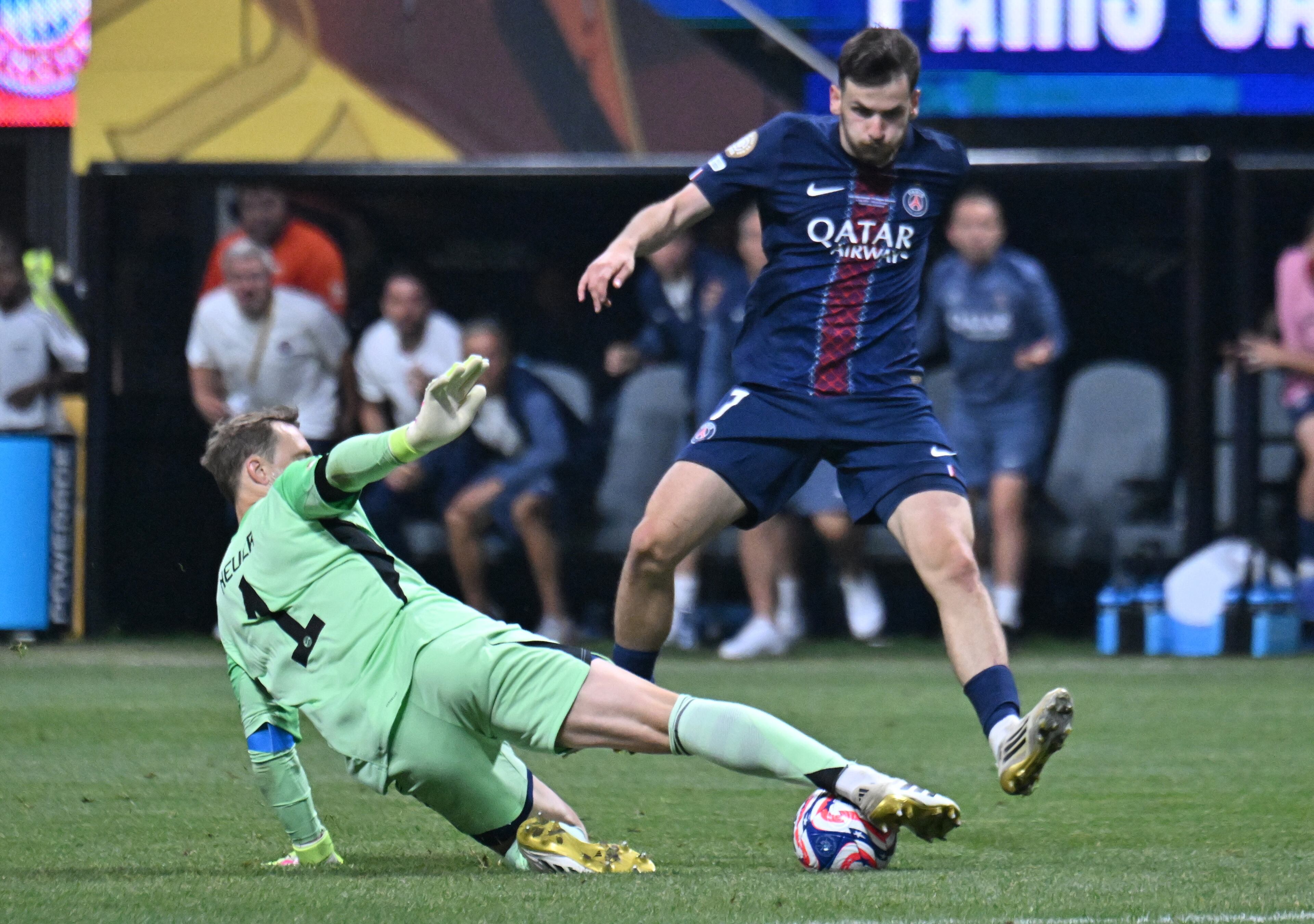 Bayern Munich goalkeeper Manuel Neuer (1) stops the ball as Paris Saint-Germain forward Khvicha Kvaratskhelia (7) takes an unsuccessful kick during the second half in Club World Cup quarterfinals match at Mercedes-Benz Stadium, Saturday, July 5, 2025, in Atlanta. Paris Saint-Germain won 2-0 over Bayern Munich. (Hyosub Shin / AJC)