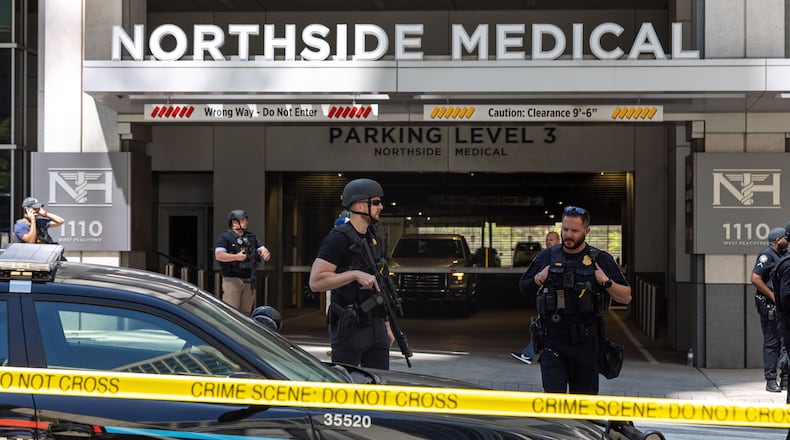 Law enforcement officers are seen on West Peachtree Street in front of Northside Hospital Midtown medical office building, where five people were shot on Wednesday, May 3, 2023. (Arvin Temkar/The Atlanta Journal-Constitution/TNS)