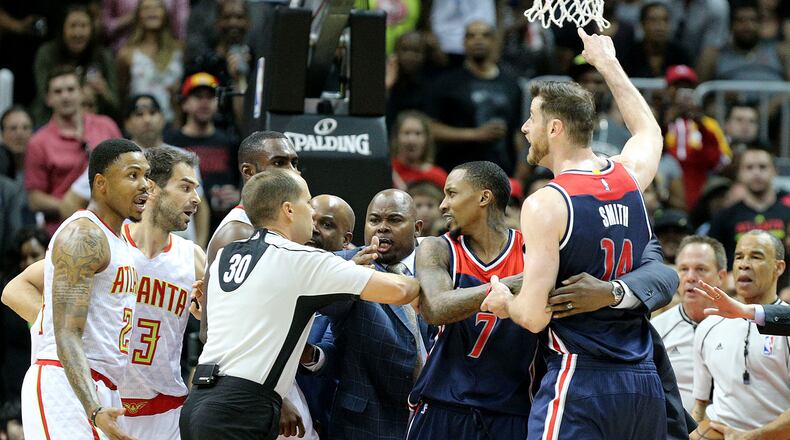 Officials separate Kent Bazemore (far left) of the Hawks and Jason Smith (far right) of the Wizards, who both received tecnical fouls, during an altercation in Game 6 of a first-round NBA basketball playoff series on Friday, April 28, 2017, in Atlanta. Curtis Compton/ccompton@ajc.com
