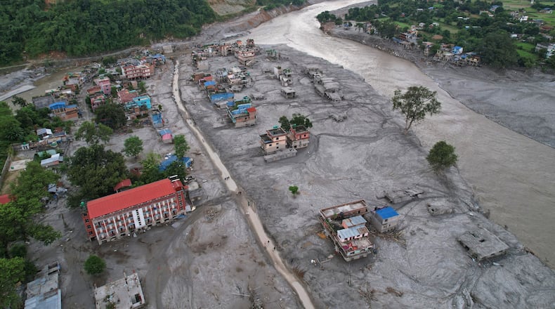 FILE - Homes are engulfed in mud in the aftermath of flash flooding along the Trishuli River in the Devighat area of Nuwakot district, Nepal, Aug. 29, 2026. (AP Photo/Rajesh Kumar Singh, File)