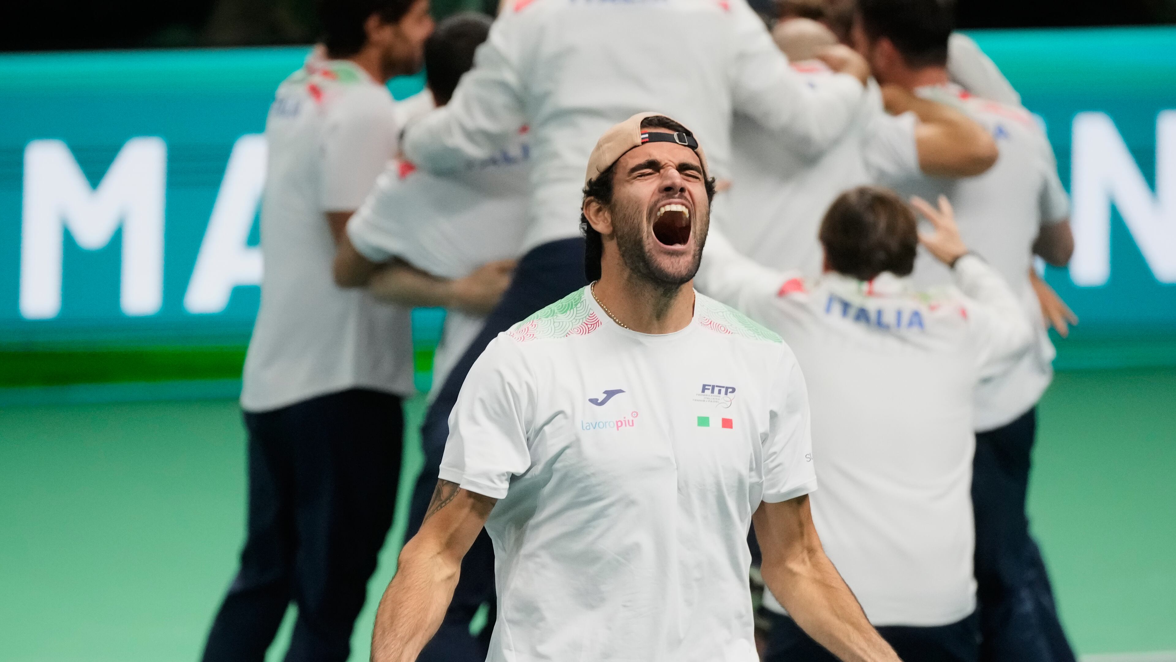 Italy's Matteo Berrettini, front, celebrates after Italy's Flavio Cobolli winning a Davis Cup final singles tennis match against Spain's Jaume Munar, in Bologna, Italy, Sunday, Nov. 23, 2025. (AP Photo/Luca Bruno)