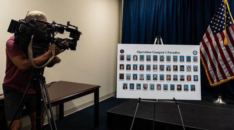 A cameraman records a board displaying individuals identified by law enforcement as members and associates of the Mexican Mafia at a news conference in Santa Ana, Calif., Thursday, April 23, 2026. (AP Photo/Jae C. Hong)