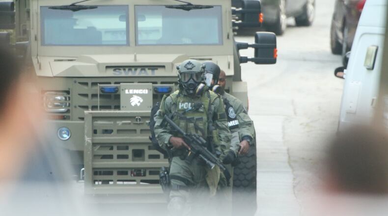 Atlanta police surrounded a home in southwest Atlanta for several hours early today, but when SWAT officers went into the house, the person whey were looking for was not there. JOHN SPINK/JOHNSPINK@AJC.COM