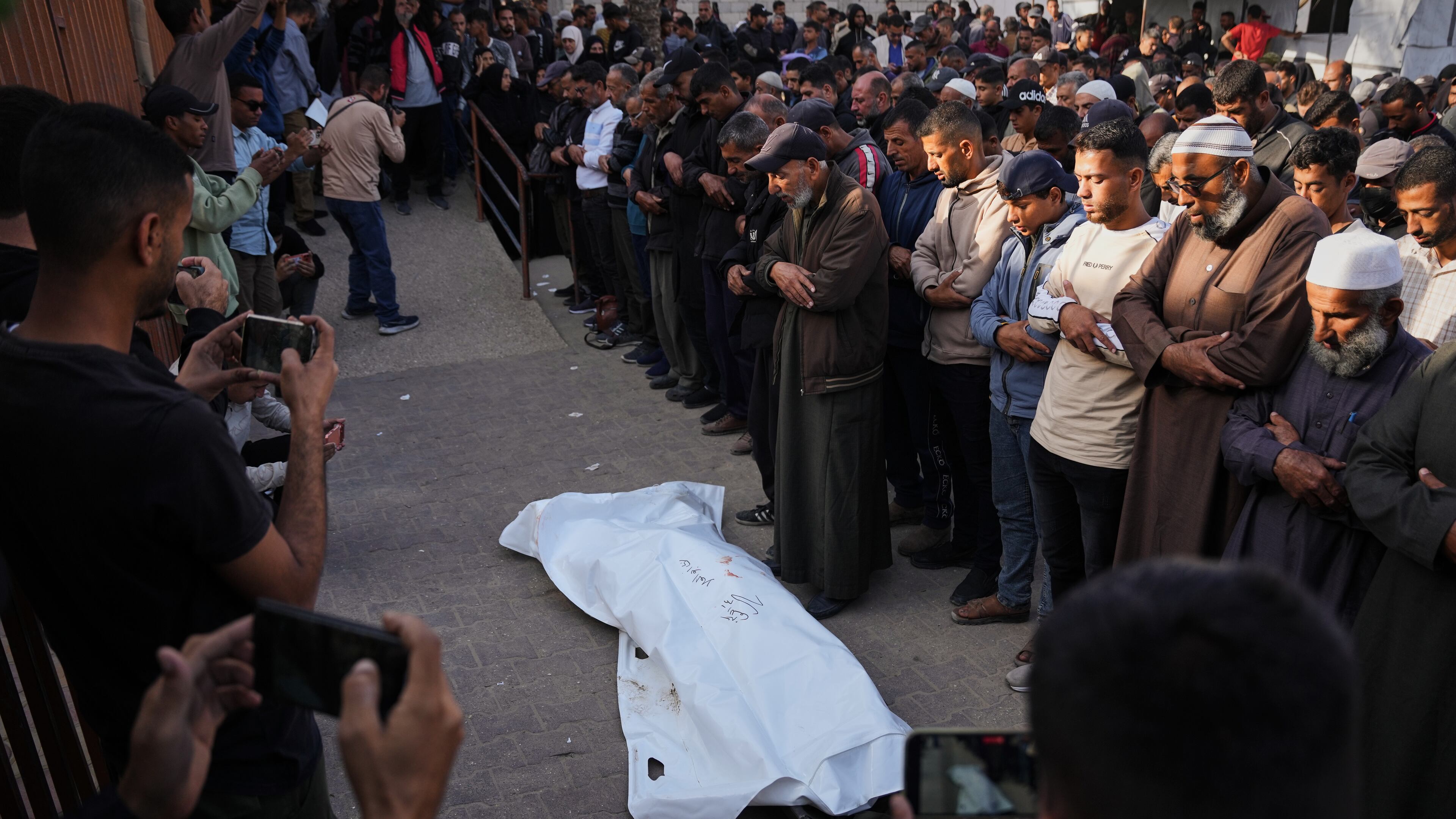 Mourners pray over the body of Ruba Abu Al-Ola, 22, killed in an Israeli army strike, during her funeral at Nasser Hospital in Khan Younis, Gaza Strip Thursday, Nov. 20, 2025. (AP Photo/Abdel Kareem Hana)