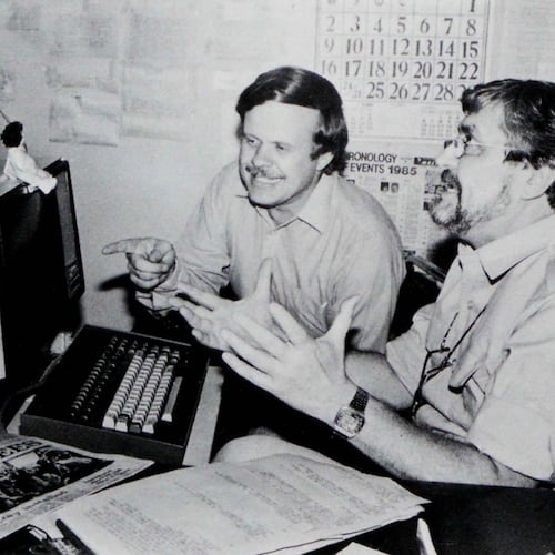 In this undated photo published in The AP World in 1986, Manila bureau chief David Briscoe, left, and Asia news director Richard Pyle discuss a story. (AP Photo)