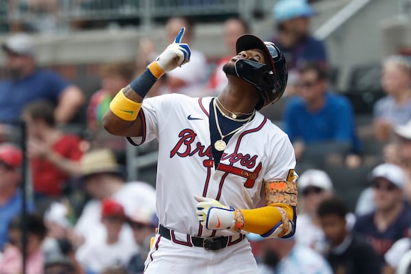 Braves outfielder Ronald Acuña Jr. thanks a higher power (and presumably prays for someone to drive him in) after a single against the Phillies.