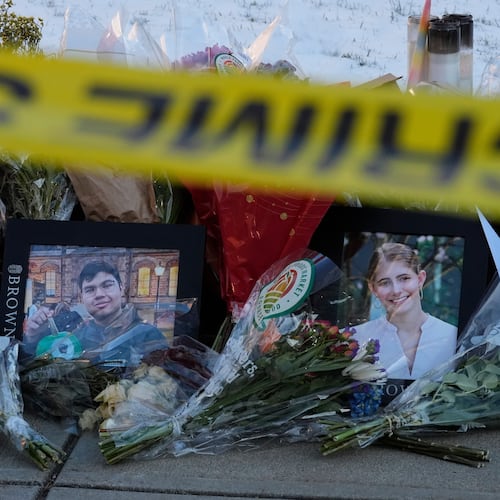 FILE - Photos of Brown University shooting victims MukhammadAziz Umurzokov, left, and Ella Cook, lay on a makeshift memorial outside the Engineering Research Center, Dec. 16, 2025, in Providence, R.I. (AP Photo/Robert F. Bukaty, File)