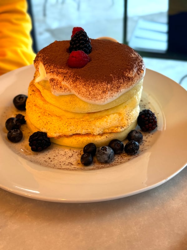 Two tall souffle-style pancakes on a plate