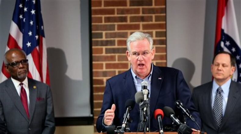 Missouri Gov. Jay Nixon, center, St. Louis County Executive Charlie Dooley, left, and St. Louis Mayor Francis Slay call for peace as they discuss preparations in anticipation of the announcement of the grand jury decision in the Darren Wilson case, on Monday, Nov. 24, 2014, at the University of Missouri-St. Louis. A grand jury has reached a decision about whether to indict the Ferguson police officer in the shooting death of unarmed 18-year-old Michael Brown. (AP Photo/The St. Louis Post-Dispatch, Huy Mach) EDWARDSVILLE INTELLIGENCER OUT, THE ALTON TELEGRAPH OUT