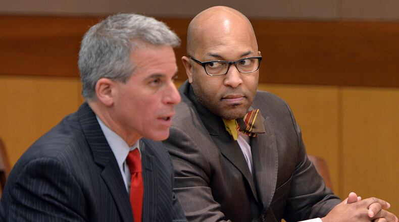 Lucious Brown (right), former principal of Kennedy Middle School, watches his attorney Brian Steel as he speaks during a plea hearing of Lucious Brown on Friday, January 17, 2014.