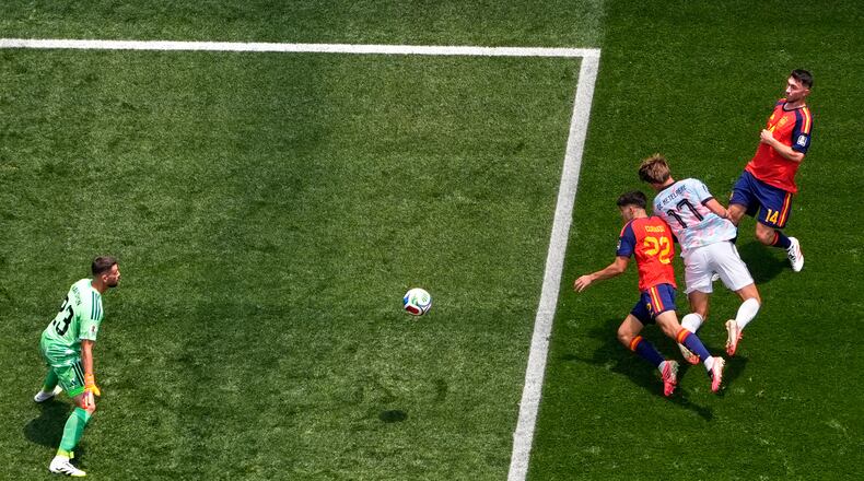 Belgium's Charles De Ketelaere (17) scores their opening goal past Spain goalkeeper Unai Simon (23) during the World Cup quarterfinal soccer match between Spain and Belgium in Inglewood, Calif., near Los Angeles, Friday, July 10, 2026. (AP Photo/Mark J. Terrill)