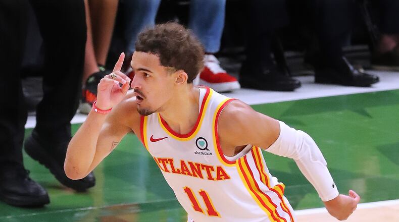 062321 Milwaukee: Atlanta Hawks guard Trae Young reacts to hitting a three pointer against the Milwaukee Bucks during a 116-113 victory in game 1 of the NBA Eastern Conference Finals at Fiserv Forum on Wednesday, June 23, 2021, in Milwaukee.   “Curtis Compton / Curtis.Compton@ajc.com”