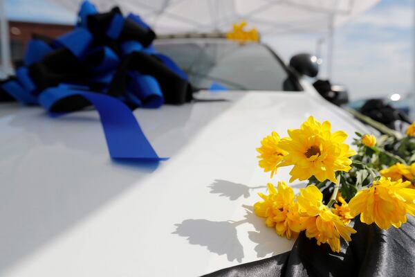 Flowers and a ribbon adorn a Savannah Police Department as a memorial to officer Reginald Brannan.