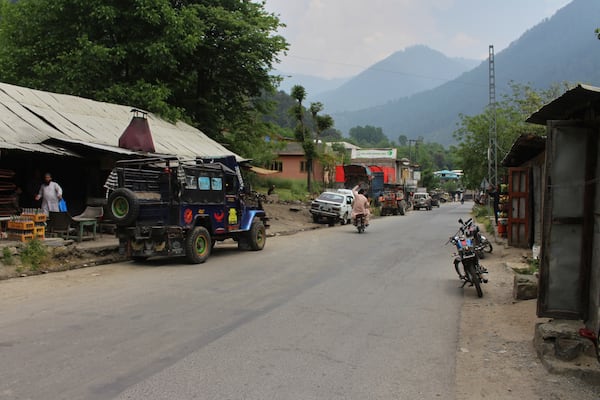 A motorcyclist drives through an empty market at a tourists point in Karen, in the Neelum Valley near on the Line of Control, the de facto border that divides the disputed region of Kashmir, some 93 kilometres (58 miles) from Muzaffarabad, the capital of Pakistan controlled Kashmir, Thursday, May 1, 2025. (AP Photo/Ishfaq Hussain)