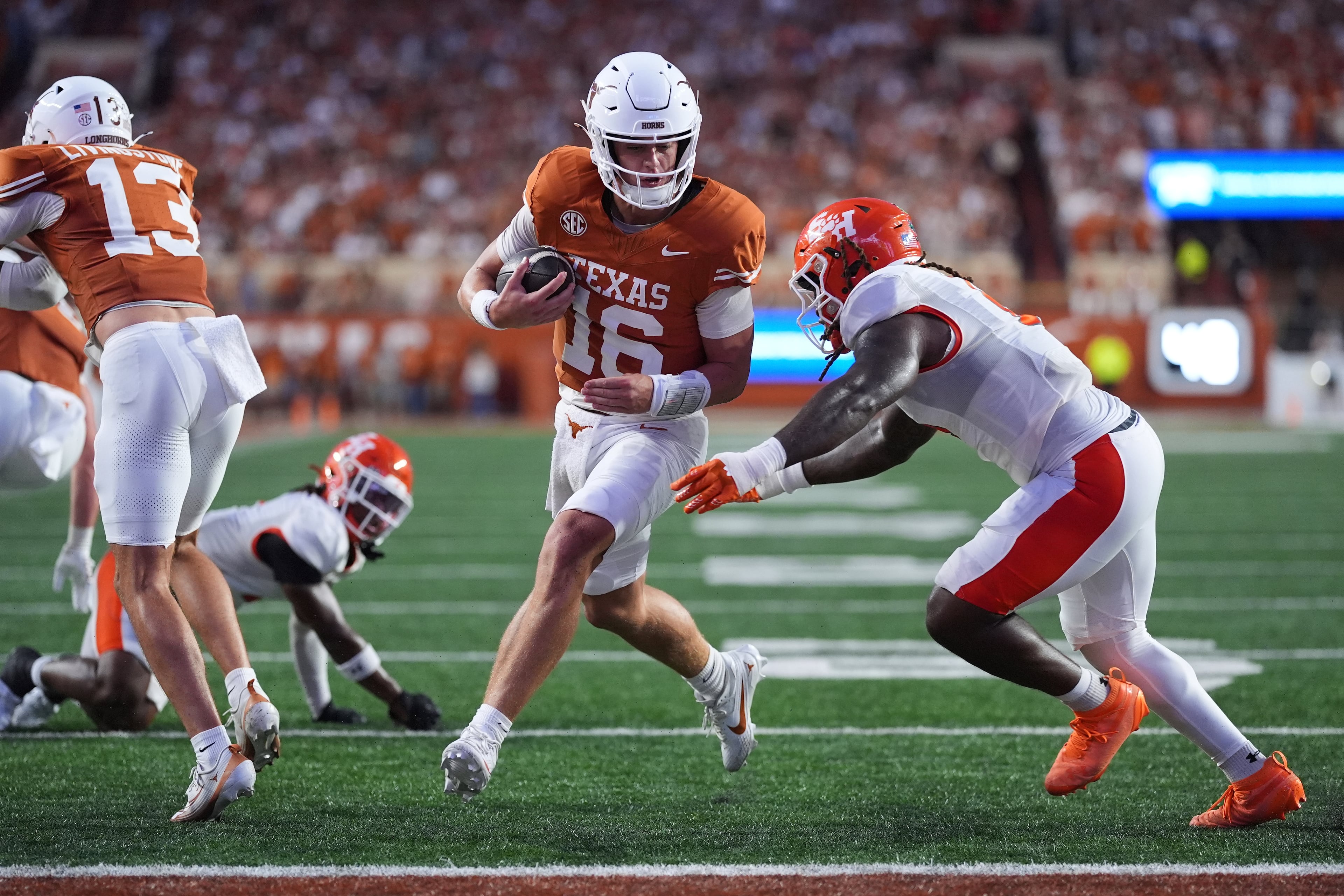 Texas quarterback Arch Manning (center) runs past Sam Houston State linebacker Antavious Fish to score a touchdown on Saturday, Sept. 20, 2025, in Austin, Texas. Manning, once a high-priority Georgia target, will have five more games under his belt by the time the Longhorns come to Athens. (Eric Gay/AP)