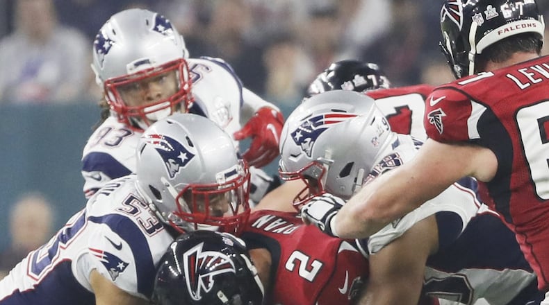 Atlanta Falcons quarterback Matt Ryan gets buried beneath New Englang rush Sunday. (Bob Andres/AJC)