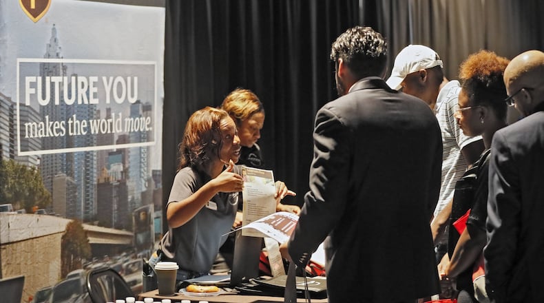 Erika Solomon, from UPS, talks with potential job applicants at a job fair earlier this month. The Opportunity ATL job and resource fair took place in East Point. Bob Andres / robert.andres@ajc.com