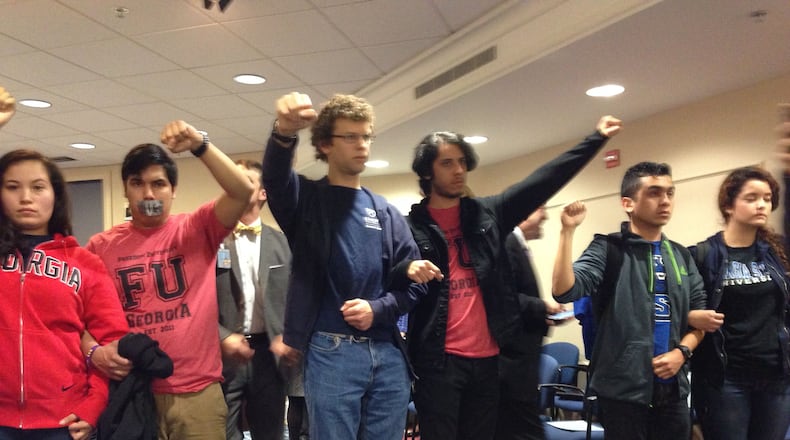 Immigrant students and their supporters protest Georgia’s college enrollment policies Tuesday during the state Board of Regents meeting in Atlanta. (Janel Davis/AJC)
