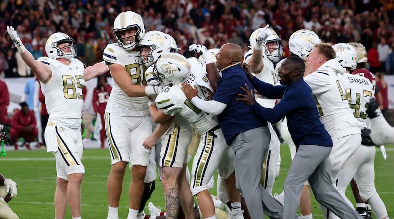 Georgia Tech players celebrate after the Yellow Jackets defeated Florida State at the Aviva Stadium in Dublin, Saturday, Aug. 24, 2024. (AP Photo/Peter Morrison)