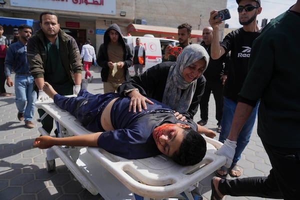 The body of Palestinian youth Ahmad Omar ,15, killed in an Israeli army airstrike of the Gaza Strip is brought to Al-Aqsa Hospital in Deir al-Balah, Sunday, April 27, 2025. (AP Photo/Abdel Kareem Hana)