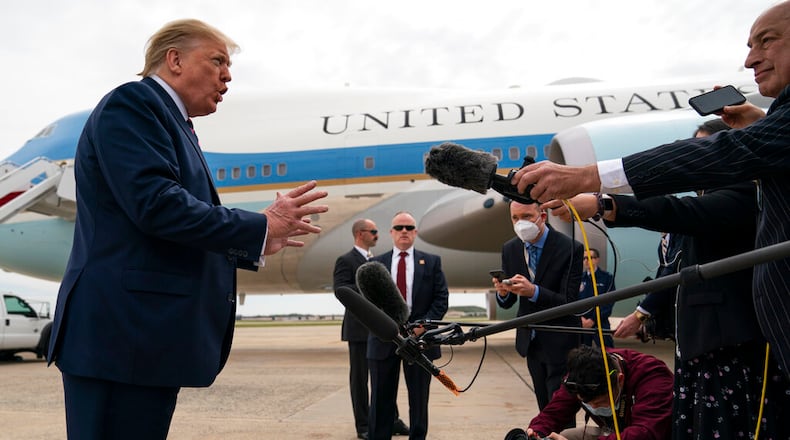President Donald Trump talks to reporters before boarding Air Force One for a trip to Phoenix to visit a Honeywell plant that manufactures protective equipment.