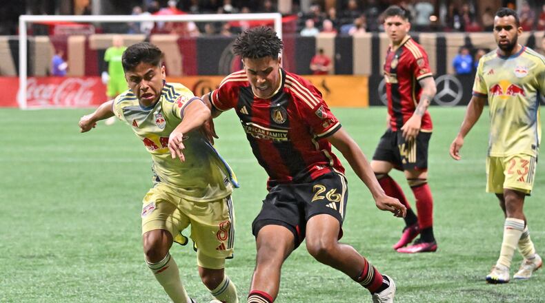 Atlanta United's defender Caleb Wiley (26) works the ball past New York Red Bulls midfielder Frankie Amaya (8) during the second half in a MLS soccer match at Mercedes-Benz Stadium, Saturday, April 1, 2023, in Atlanta. (Hyosub Shin / Hyosub.Shin@ajc.com)